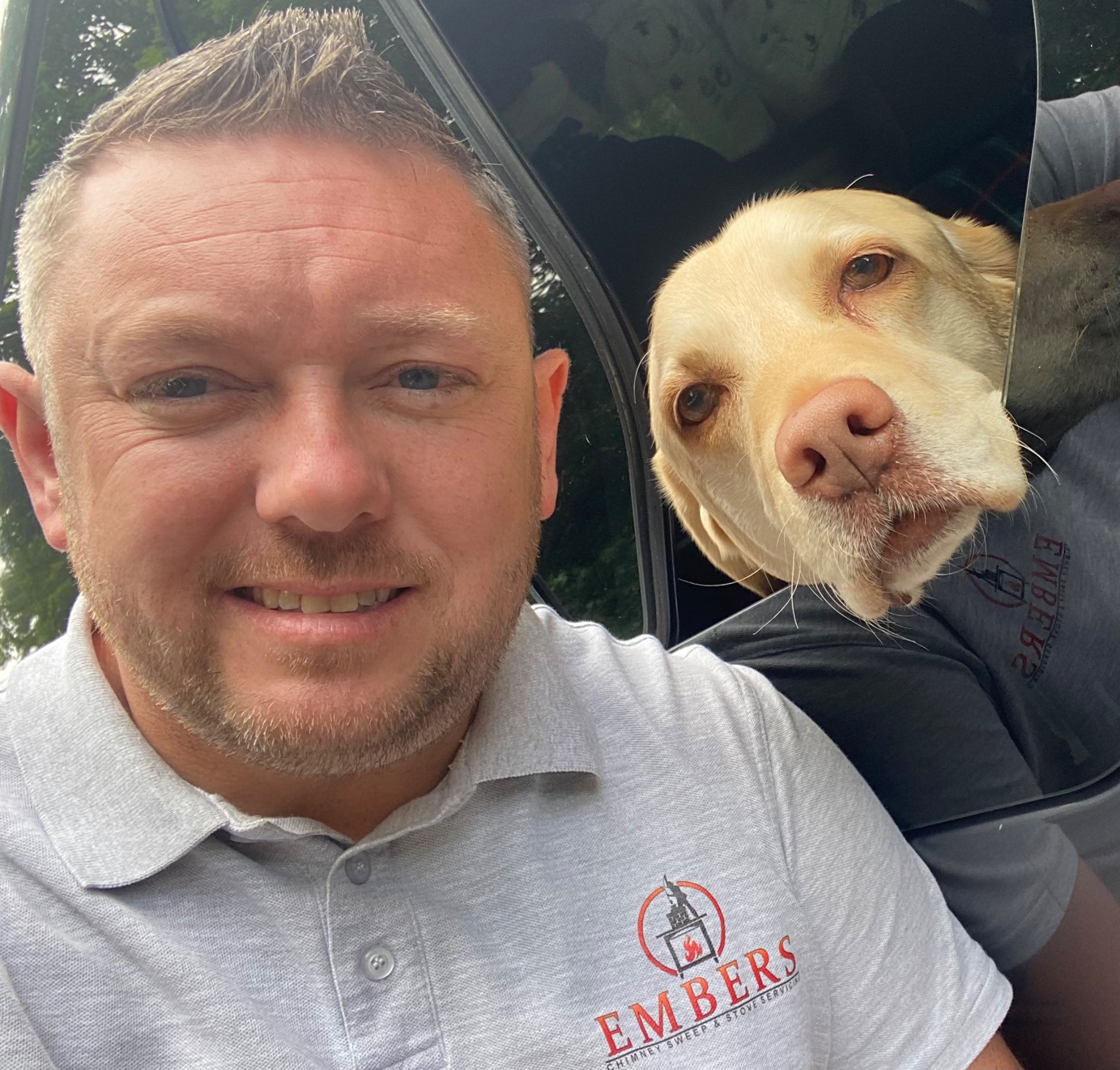Peter from Embers with Lottie looking out from the Embers van